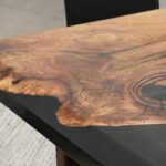 Close-up view of the epoxy resin detail on the Sylva Home custom black walnut dining river table, model ET9.