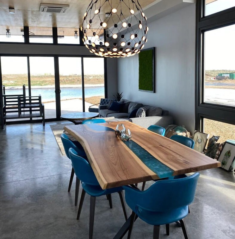 Side view of the Sylva Home custom black walnut epoxy blue river table, model ET10, showcasing the table’s edge and design.