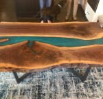 Angled view of the Sylva Home custom black walnut epoxy resin blue river table, model ET11, showing the table’s depth and texture.