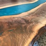 Detailed view of the blue river pattern created by the epoxy resin on the Sylva Home custom black walnut table, model ET11.