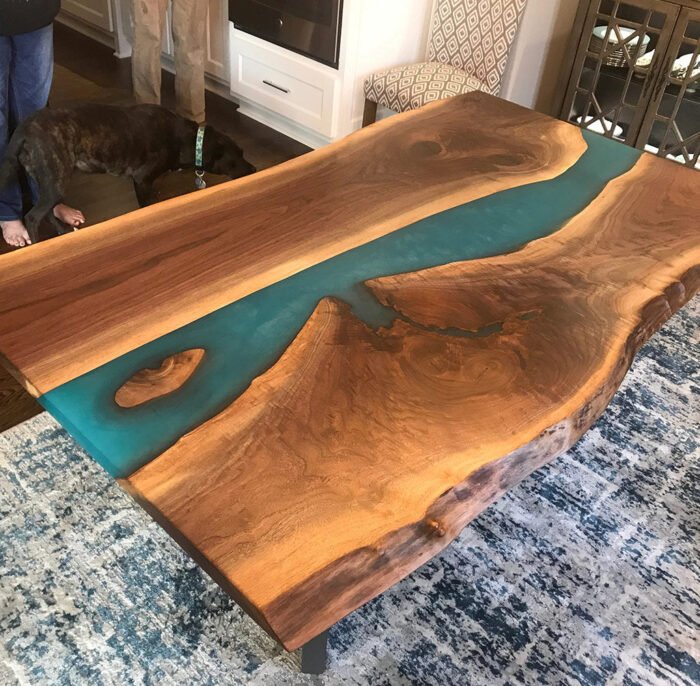 Side view of the Sylva Home custom black walnut epoxy resin blue river table, model ET11, showcasing the table’s edge and design.