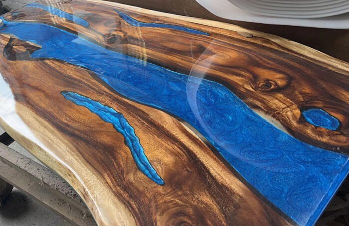 Angled view of the Sylva Home custom black walnut epoxy resin river table, model ET2, showcasing its overall aesthetic.