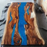 Close-up view of the epoxy resin detail on the Sylva Home custom black walnut epoxy resin river table, model ET2.