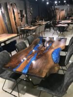 Full view of the Sylva Home custom black walnut live edge blue epoxy river table, model ET50, highlighting its design and finish.