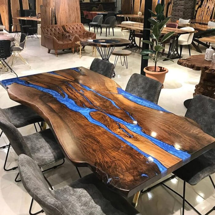 Side view of the Sylva Home custom black walnut live edge blue epoxy river table, model ET50, showcasing the table's edge and legs.