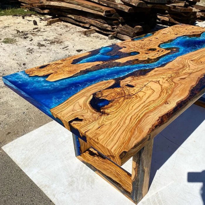 Angled view of the Sylva Home custom blue epoxy resin river table, model ET13, showing the table’s depth and texture.