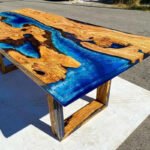 Side view of the Sylva Home custom blue epoxy resin river table, model ET13, showcasing the table’s edge and design.