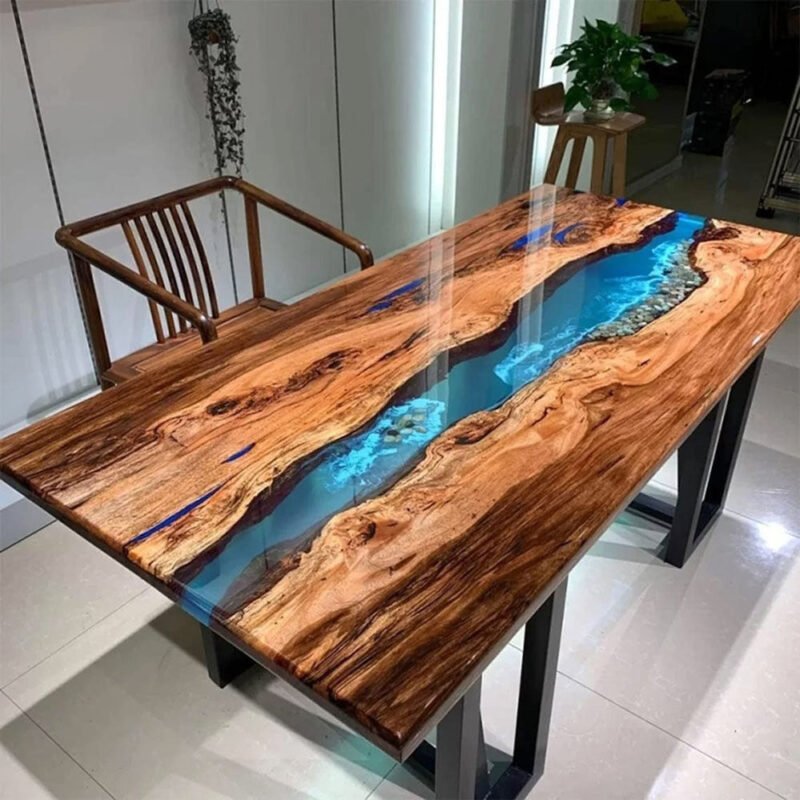 Side view of the Sylva Home custom epoxy walnut blue river dining table, model ET27, showcasing the table's edge and legs.