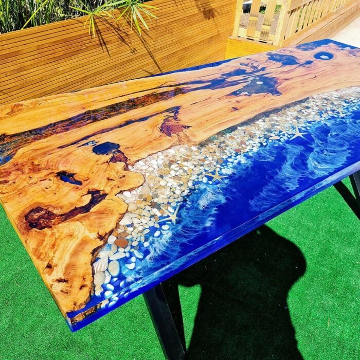 Angled view of the Sylva Home custom ocean epoxy resin dining table, model ET3, showing the table's depth and texture.