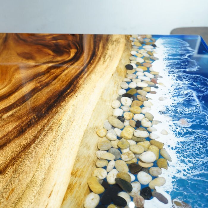 Close-up view of the epoxy resin detail on the Sylva Home custom ocean wave walnut epoxy dining table, model ET24.