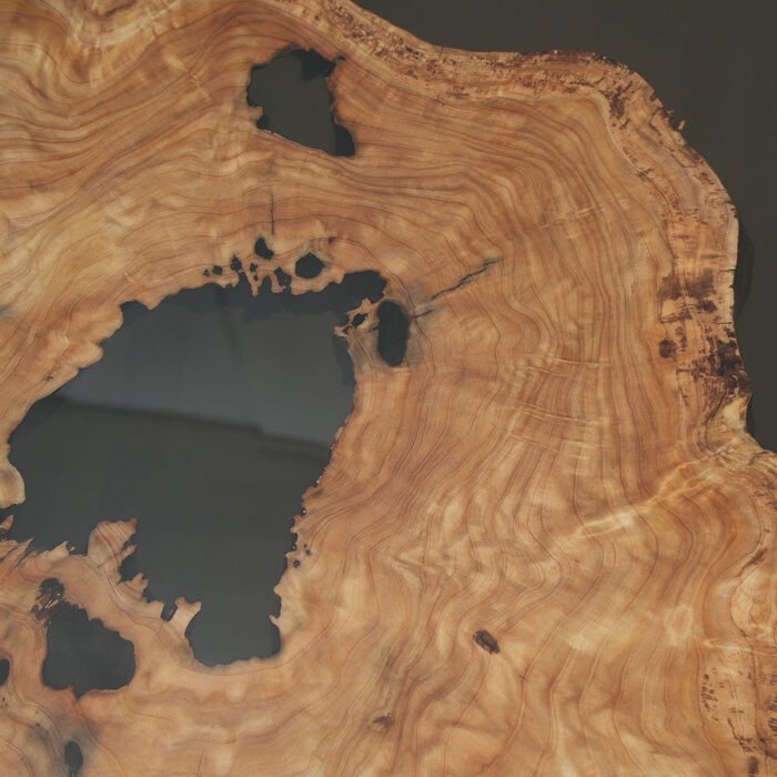 Close-up view of the epoxy resin detail on the Sylva Home custom olive wood epoxy dining table, model ET48.