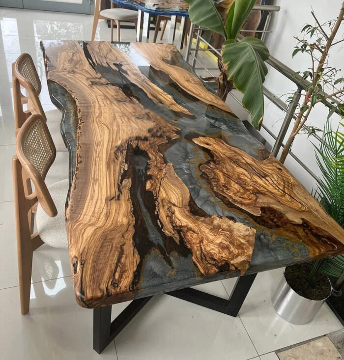 Angled view of the Sylva Home custom olive wood epoxy river dining table, model ET40, showcasing its overall aesthetic.