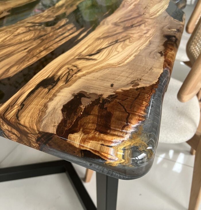 Detailed view of the table leg design on the Sylva Home custom olive wood epoxy river dining table, model ET40.