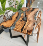 View of the river pattern created by the epoxy resin on the Sylva Home custom olive wood epoxy river dining table, model ET40.