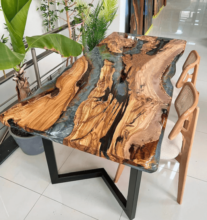 View of the river pattern created by the epoxy resin on the Sylva Home custom olive wood epoxy river dining table, model ET40.