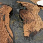 Close-up of the table surface finish on the Sylva Home custom olive wood epoxy river dining table, model ET40.