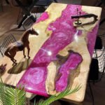 Side view of the Sylva Home custom pink epoxy resin river table top, model ET41, showcasing the table's edge.