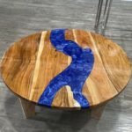 Close-up view of the epoxy resin detail on the Sylva Home custom blue epoxy river coffee table, round model ET74.