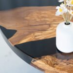 Angled view of the Sylva Home custom round epoxy coffee table, model ET69, showcasing its overall aesthetic.