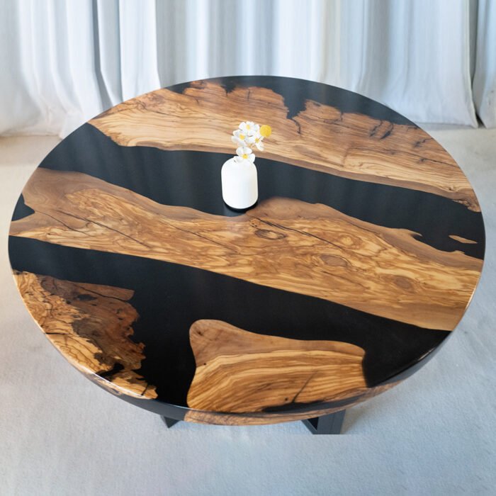 Full view of the Sylva Home custom round epoxy coffee table, model ET69, highlighting its design and finish.