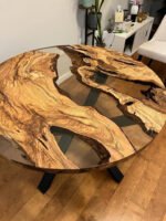 Angled view of the Sylva Home custom round epoxy river coffee table, model ET76, showcasing its overall aesthetic.