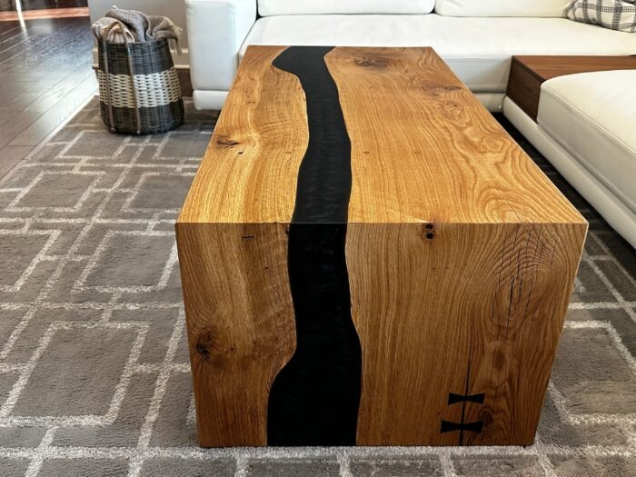 Side view of the Sylva Home custom waterfall river epoxy coffee table, model ET67, showcasing the table's edge and legs.